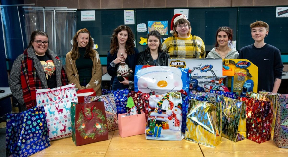 Picture of SERC A Levels students with gifts and parcels for charities. 